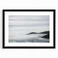 Framed wall art featuring a serene landscape design with mist and fog, presented in a sleek black frame with a mat. Ideal for home decor and art enthusiasts.