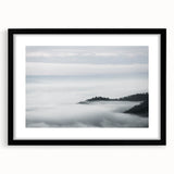 Framed wall art featuring a serene landscape design with mist and fog, presented in a sleek black frame with a mat. Ideal for home decor and art enthusiasts.