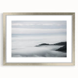 Framed wall art featuring a serene landscape design with mist and fog, presented in a stylish silver frame with a mat, ideal for enhancing home decor.