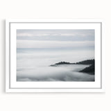 Framed wall art featuring a serene landscape design with mist and fog, presented in a sleek white frame with a mat, ideal for modern home décor. This elegant piece enhances interior spaces, creating a calming atmosphere.