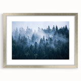 Framed wall art featuring a misty landscape design in soft gray and blue tones, accented with a sleek silver frame and white matting, perfect for modern home decor.