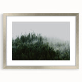 Framed wall art collection showcasing a serene misty landscape design with soft gray and silver tones, set in a sleek silver frame with a white mat. Perfect for home decor.