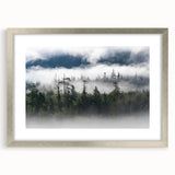 Framed wall art featuring a serene landscape design with mist and fog, presented in a silver frame with a mat, perfect for enhancing modern home decor.