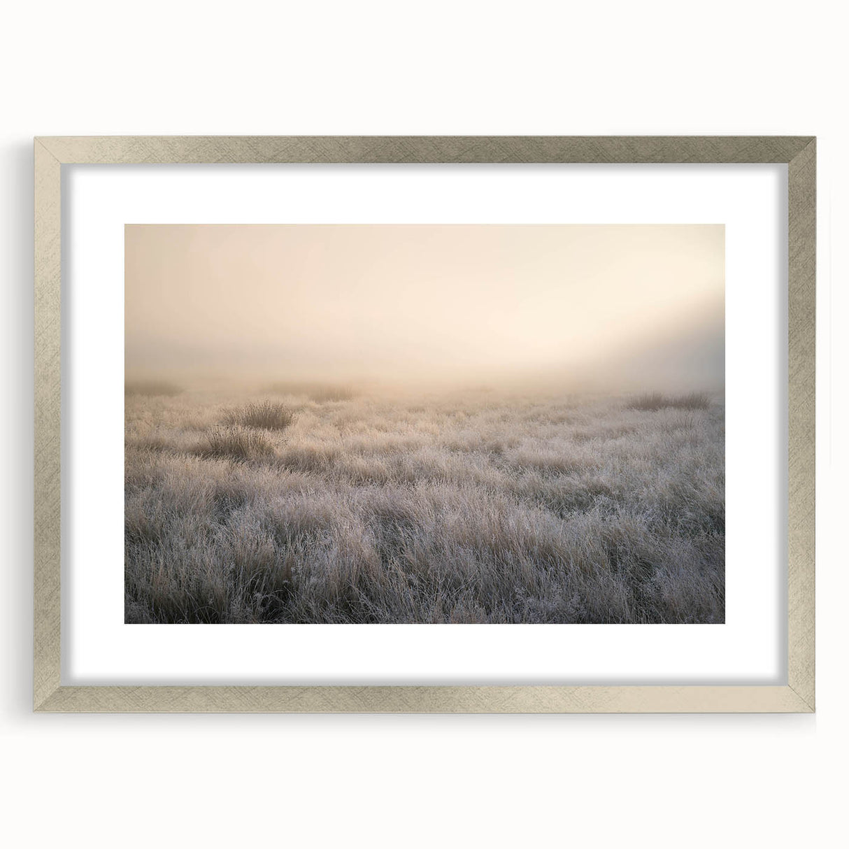 Framed wall art featuring a serene landscape design with misty fog, accented by a silver frame and mat, perfect for enhancing home decor. Ideal for nature lovers.