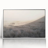 Framed wall art depicting a serene misty landscape, featuring soft hues of gray and white, perfect for enhancing modern home decor. The acrylic finish adds a sleek touch, making it an elegant addition to any living space.