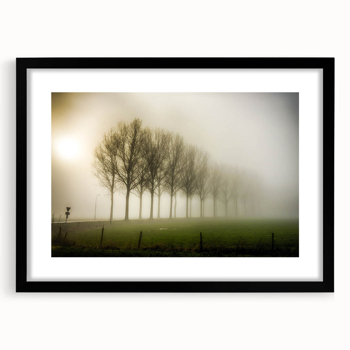 Framed wall art showcasing a serene misty landscape design in muted colors, featuring a black frame and matting, perfect for home decor enhancement.