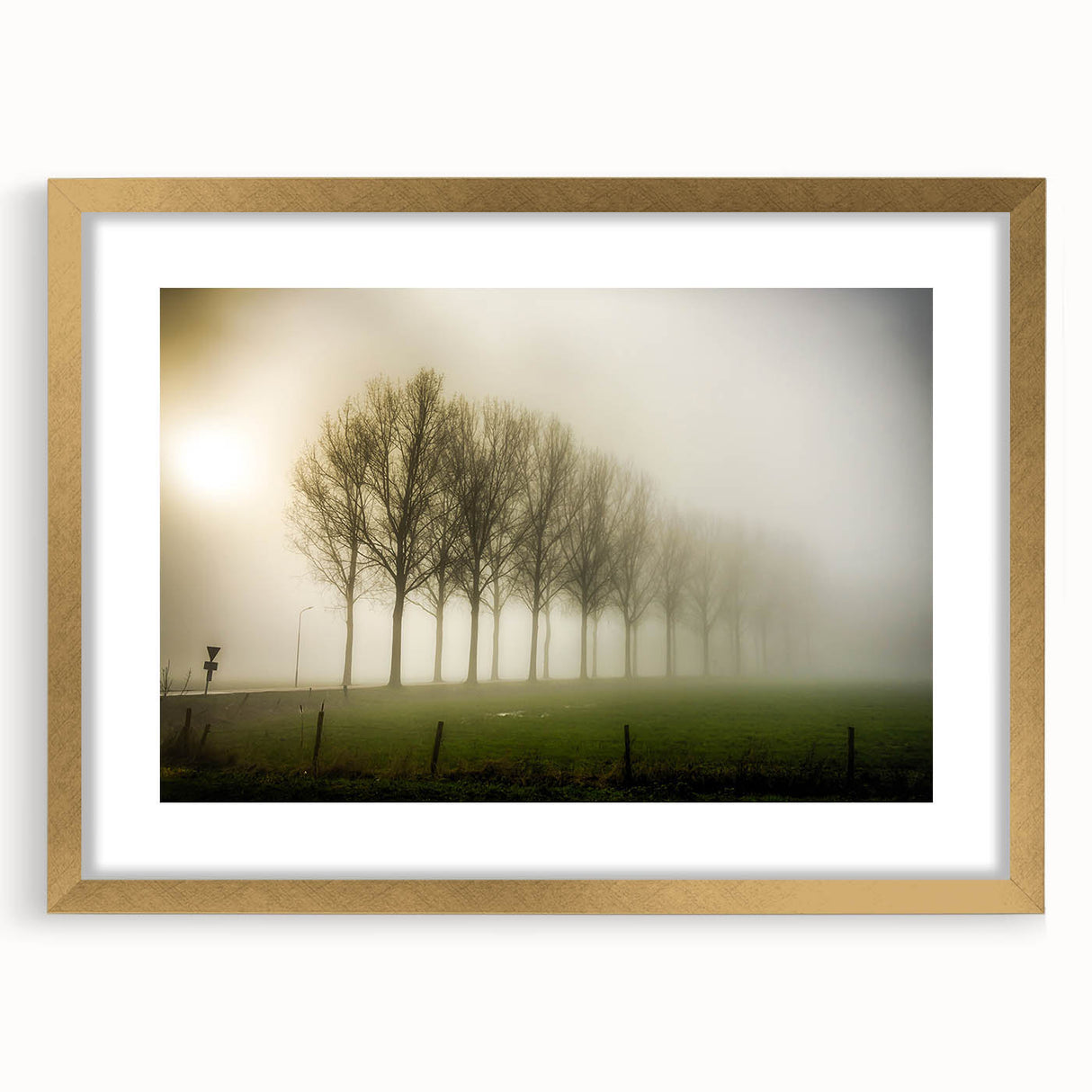 Elegant gold-framed wall art featuring a misty landscape design, perfect for adding a serene touch to home decor. The artwork is complemented by a stylish mat, enhancing its visual appeal.