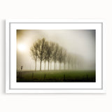 Framed wall art featuring a serene landscape design with mist and fog, presented in a sleek white frame with a mat, ideal for home or office decor.
