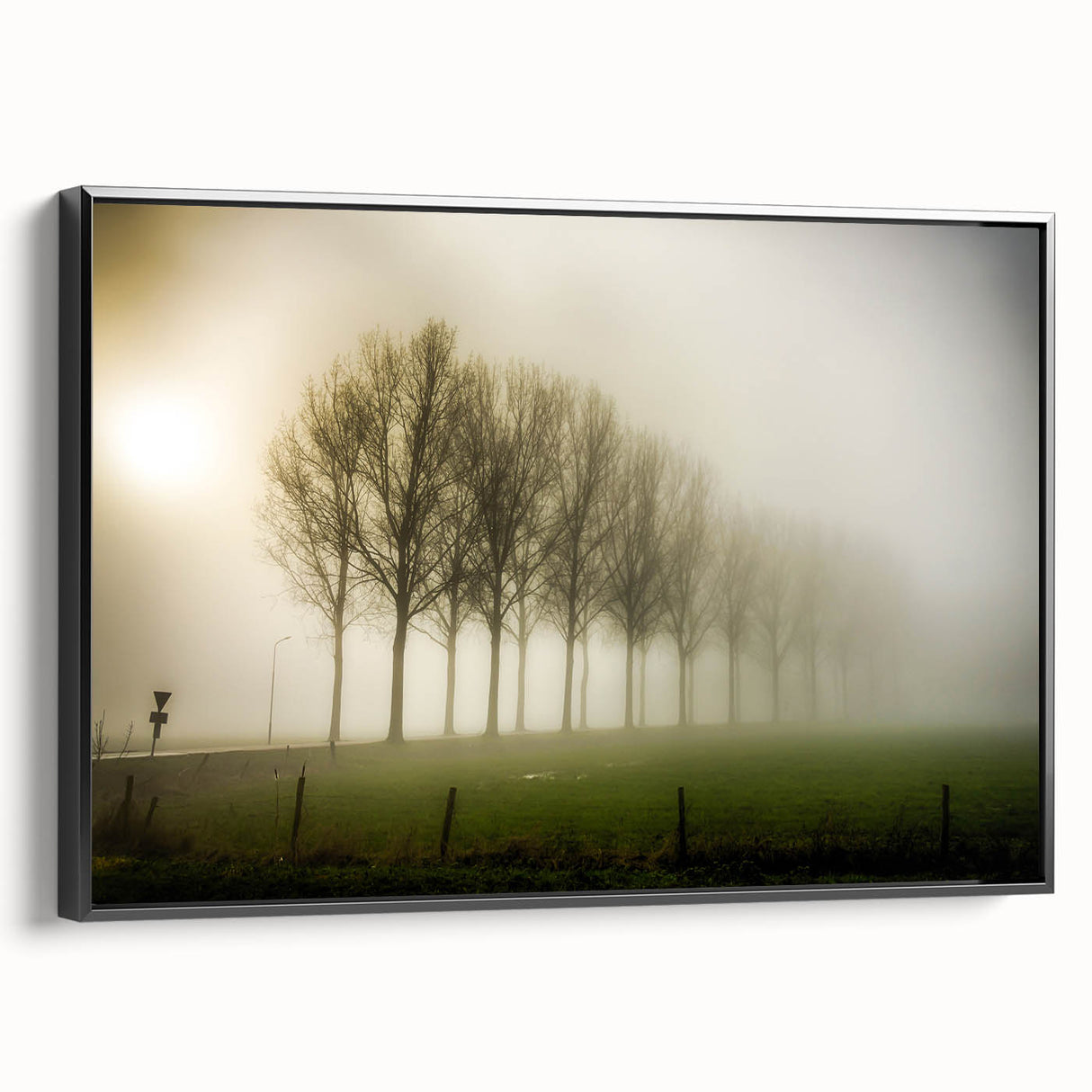Framed canvas artwork showcasing a misty landscape design with soft fog and muted colors, displayed in a sleek black frame, ideal for modern home decor.
