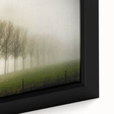 Close-up of a framed canvas wall art piece showcasing a serene landscape design with mist and fog, featuring soft gray and green hues that evoke tranquility. Perfect for home decor, this artwork adds a calming touch to any room.