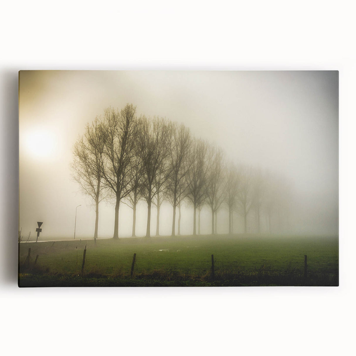 Stretched canvas wall art showcasing a serene misty landscape with soft fog enveloping trees and hills, creating a tranquil atmosphere for home decor.