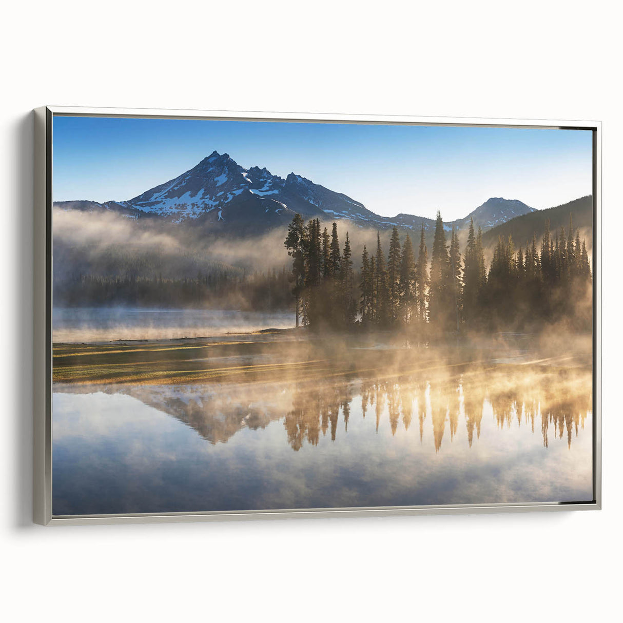 Framed canvas wall art showcasing a serene landscape design with mist and fog, featuring a silver frame. Perfect for adding a calming touch to modern home decor.