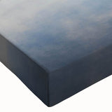 Close-up of a stretched canvas wall art piece depicting a serene landscape enveloped in mist, showcasing soft hues of blue and gray, ideal for home decor.