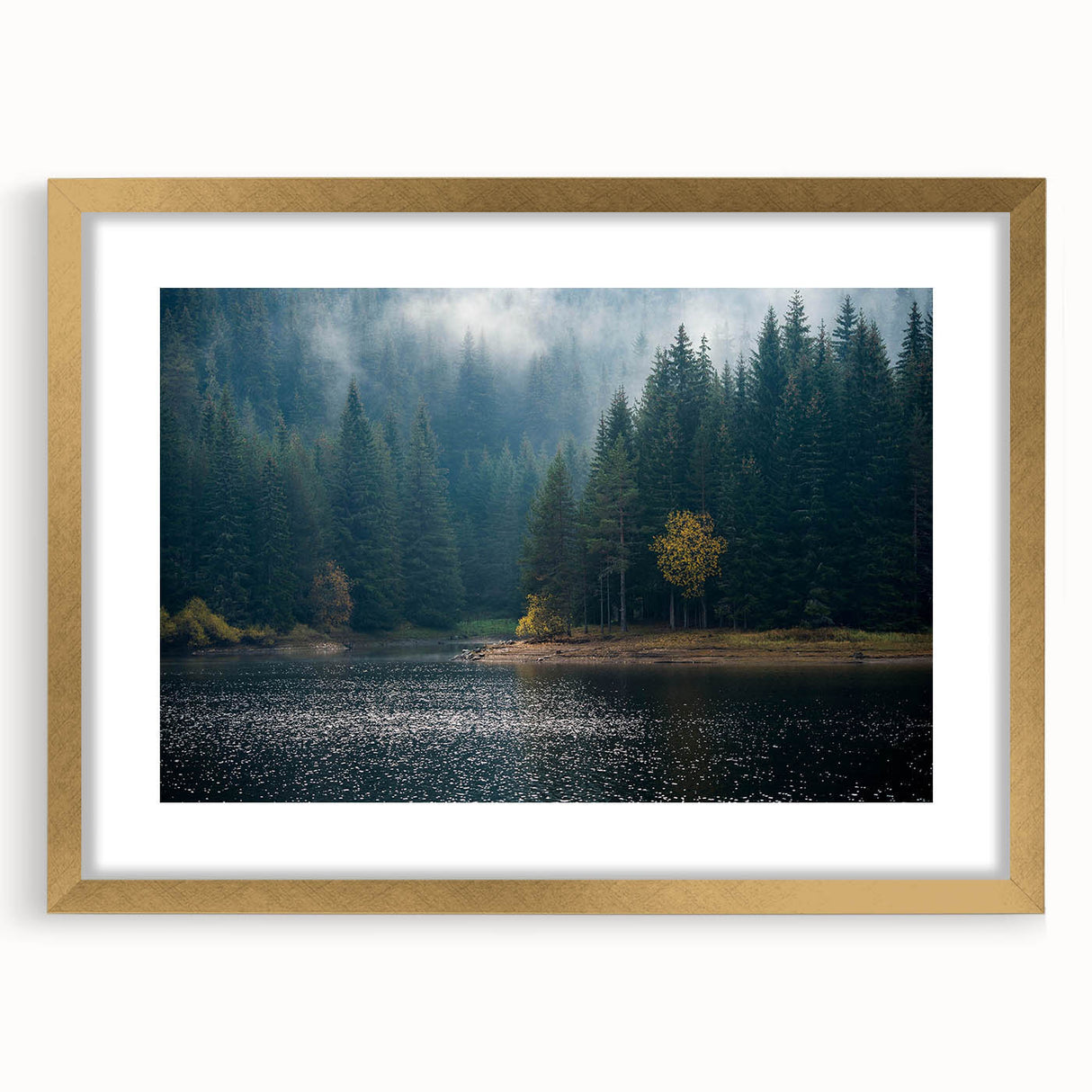 Framed wall art collection showcasing a misty landscape design with soft hues of blue and gray, accented by a gold frame and mat, perfect for modern home decor.