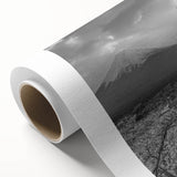 Stunning rolled canvas artwork depicting a serene mountain landscape at sunset, showcasing vibrant hues of orange and purple, perfect for home decor.