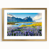 Framed wall art featuring a stunning landscape of majestic mountains, presented in a gold frame with a mat, perfect for enhancing home decor.