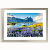 Framed wall art showcasing a stunning mountain landscape design, featuring a sleek silver frame with a white mat, perfect for enhancing any room's decor.