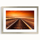 Framed landscape wall art featuring a railroad design, elegantly bordered with a silver mat, perfect for enhancing home decor and adding a modern touch.