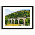Framed wall art collection showcasing a scenic railroad landscape design with a black mat and frame, ideal for home decor enthusiasts.
