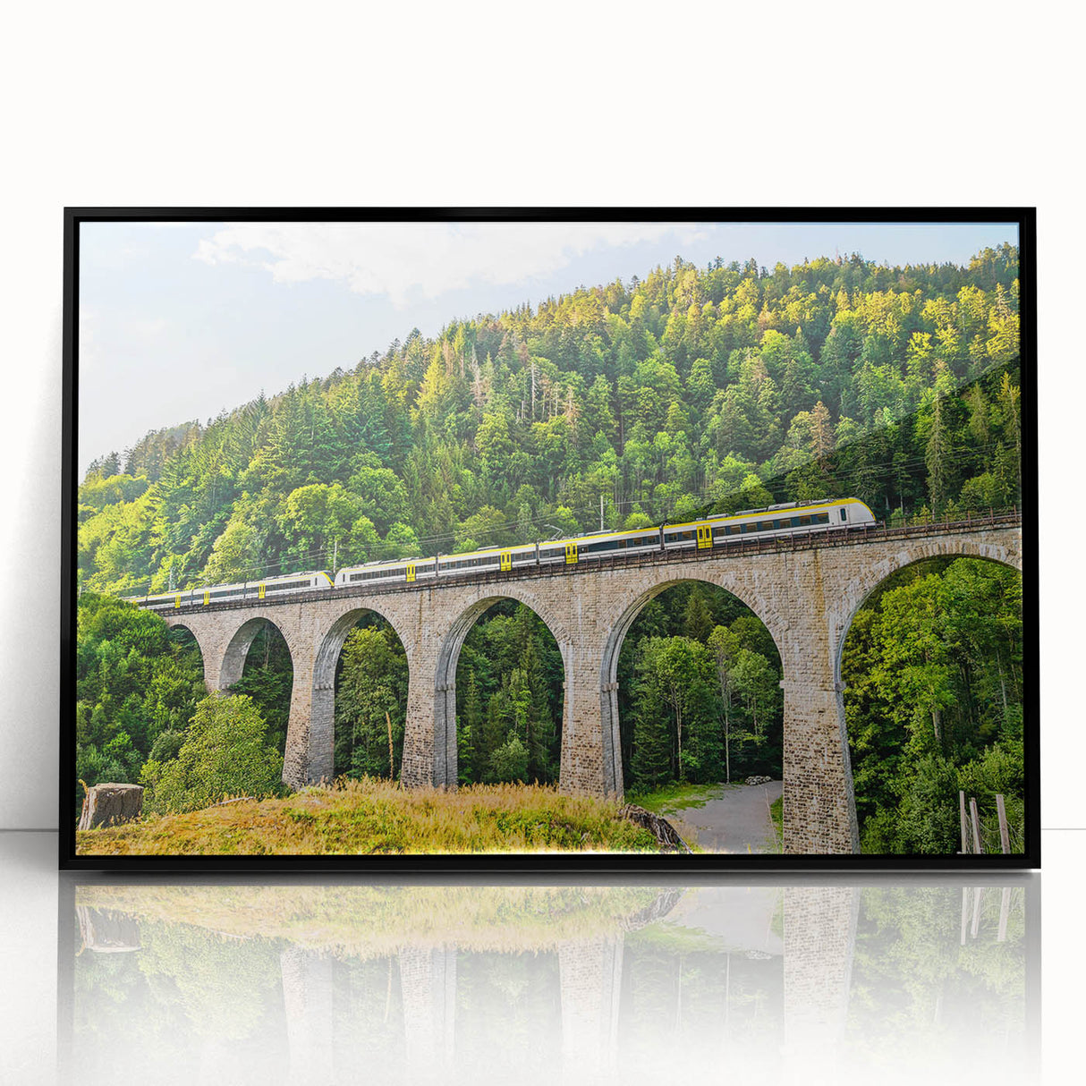 Framed wall art collection featuring a picturesque landscape with a railroad design, showcasing vibrant colors and intricate details against a black frame, perfect for home decor.