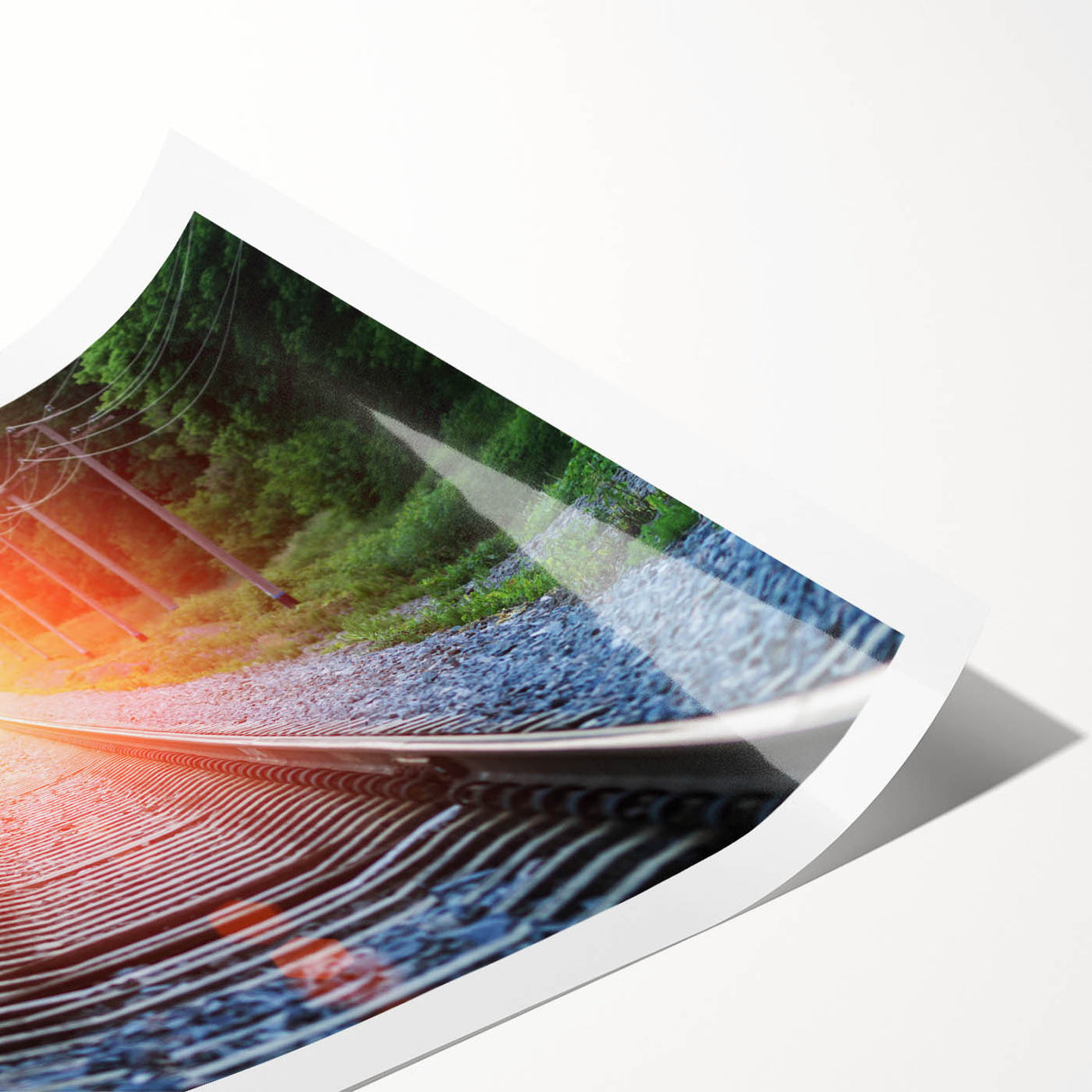 Rolled print of a vibrant landscape featuring a railroad track winding through lush greenery, showcasing detailed colors and textures, perfect for wall decor.