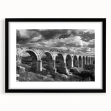Framed black wall art featuring a scenic railroad landscape design, showcasing vibrant colors and intricate details, perfect for enhancing home decor.
