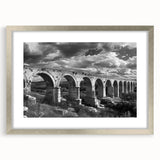 Framed wall art collection featuring a scenic landscape with railroads, displayed in a sleek silver frame with a mat, perfect for home décor enhancement.