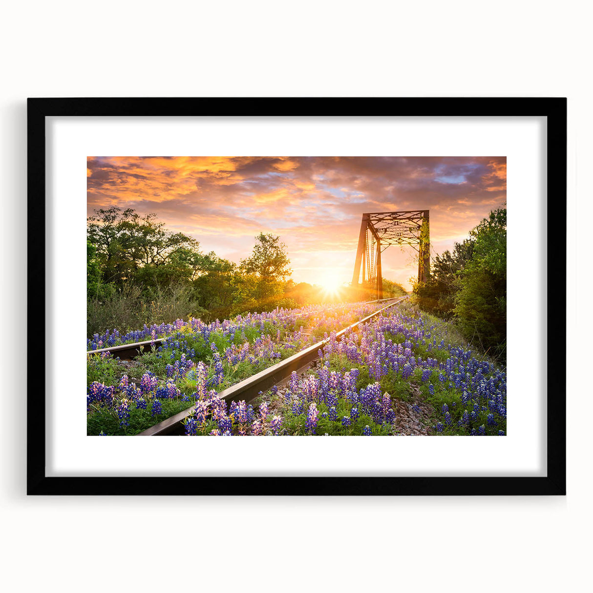 Framed wall art featuring a scenic railroad landscape design, elegantly matted and presented in a sleek black frame, ideal for home decor enhancement.