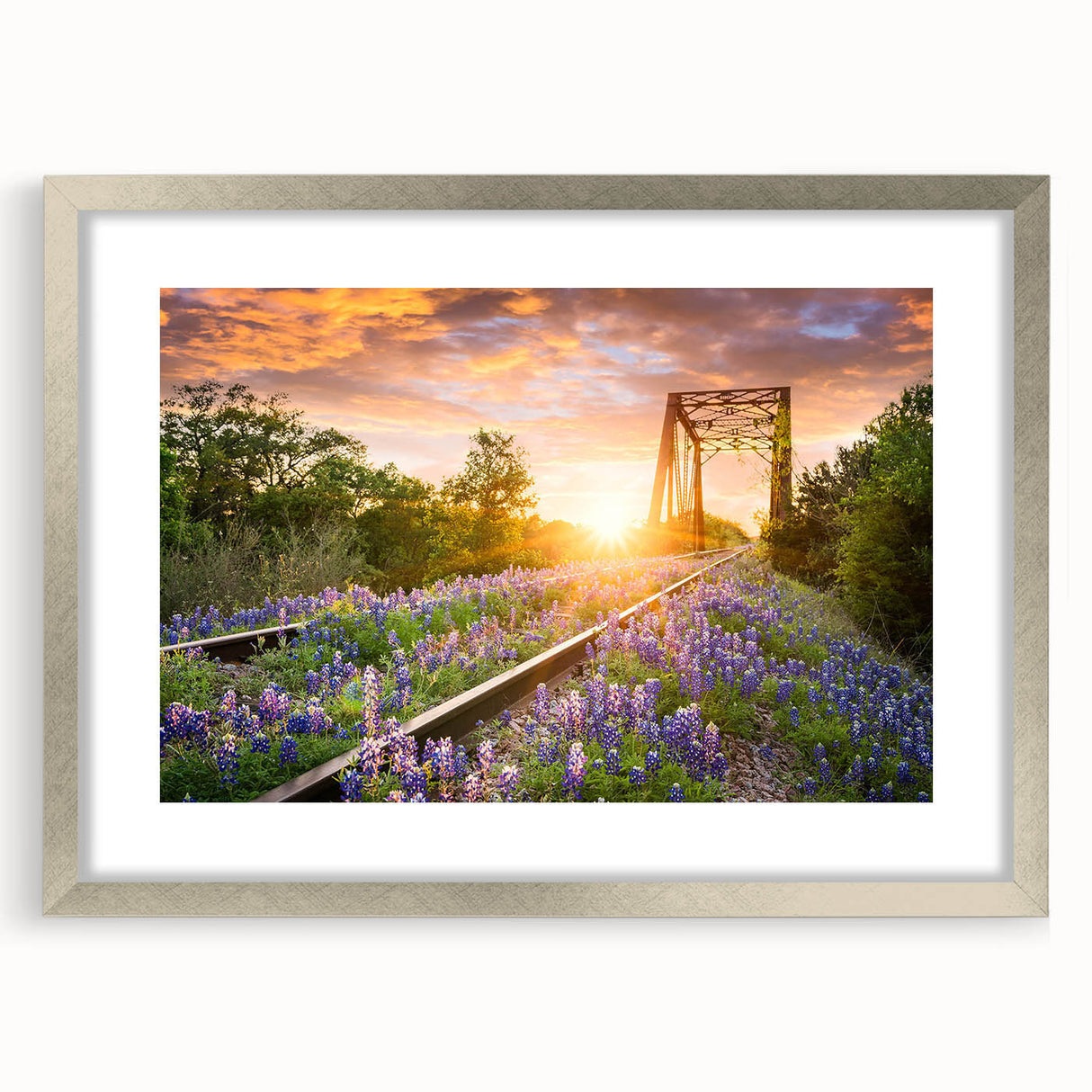 Framed wall art featuring a stunning landscape design of a railroad scene, presented in a sleek silver frame with a mat, ideal for home decor and art enthusiasts.
