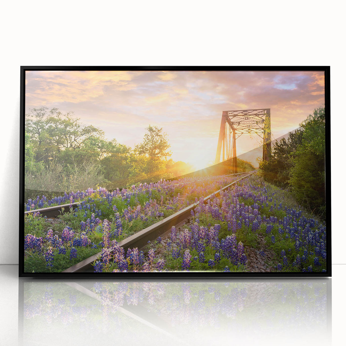 Framed acrylic wall art displaying a vibrant landscape with railroads, set against a black background, perfect for contemporary home decor.