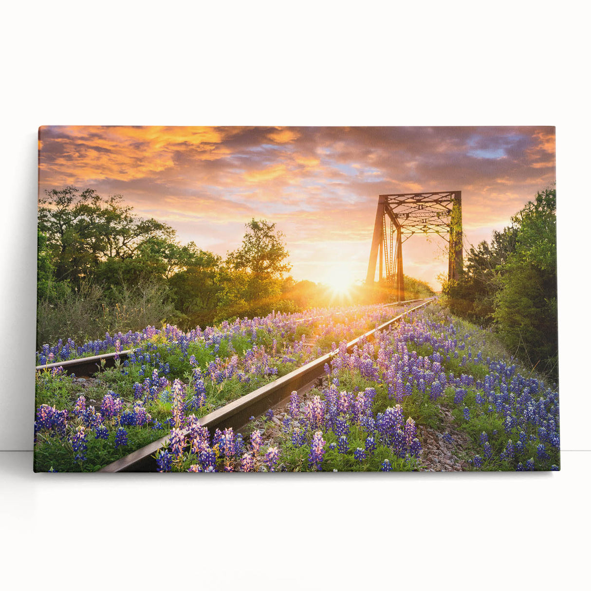 Stretched canvas wall art showcasing a vibrant landscape scene with railroad tracks stretching into the distance, ideal for enhancing home decor with a touch of adventure.