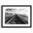 Framed wall art featuring a scenic railroad landscape design with a black matte frame, perfect for home decor, enhancing living spaces with a touch of nature.
