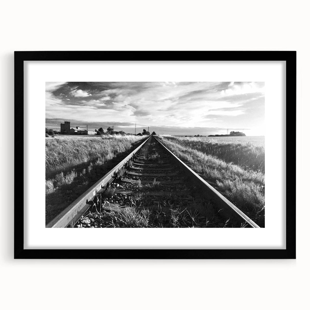 Framed wall art featuring a scenic railroad landscape design with a black matte frame, perfect for home decor, enhancing living spaces with a touch of nature.