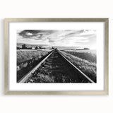 Framed wall art featuring a serene landscape with railroad tracks, silver matting, and a sleek frame, perfect for enhancing modern home decor.