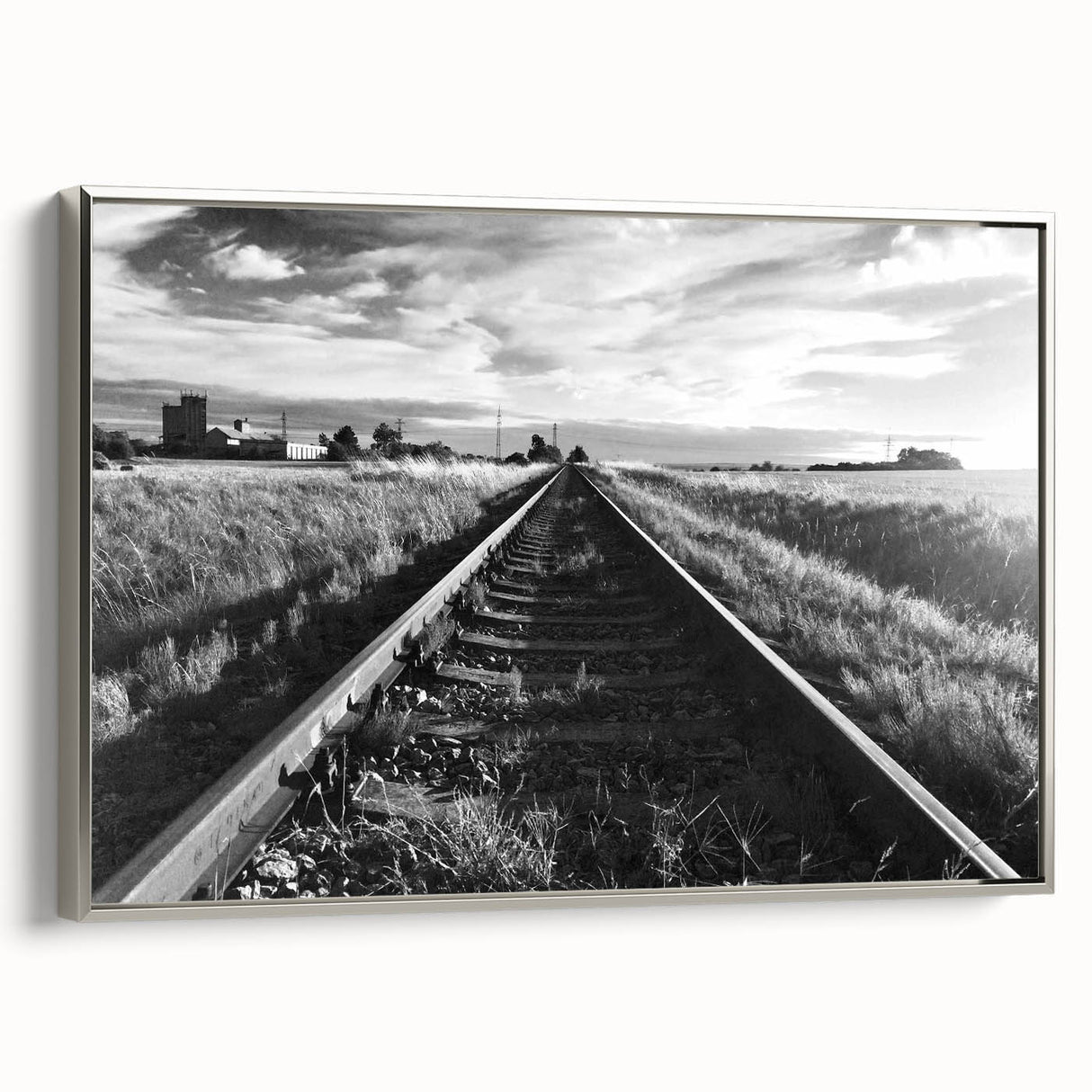 Framed canvas wall art showcasing a scenic landscape with railroads, featuring a silver frame, perfect for enhancing modern home decor. This artistic piece highlights the beauty of railroads amidst nature, ideal for living rooms or offices.