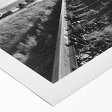 Rolled canvas showcasing a vibrant landscape design with railroad tracks, featuring rich colors and intricate details, ideal for enhancing home decor.