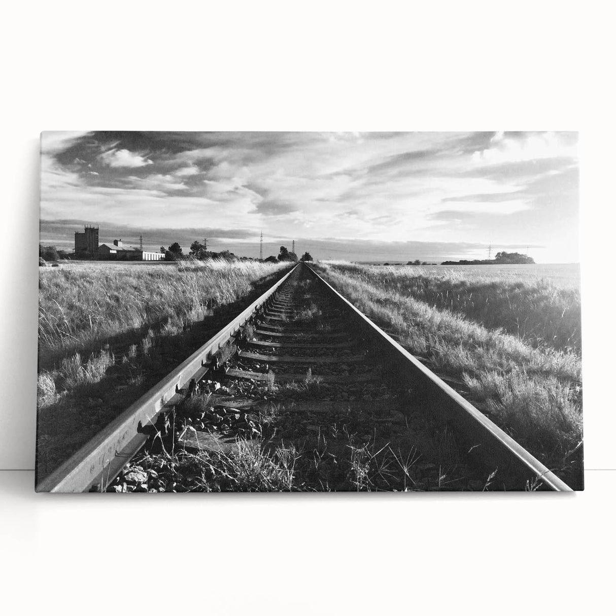 Stretched canvas wall art featuring a serene landscape with a railroad track winding through lush greenery, perfect for home decor or office ambiance. The vibrant colors and detailed scenery evoke a sense of tranquility and adventure, enhancing any interior space.