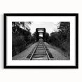 Framed wall art featuring a stunning landscape of railroads, presented in a sleek black frame with a mat. Perfect for enhancing home decor and showcasing artistic design.