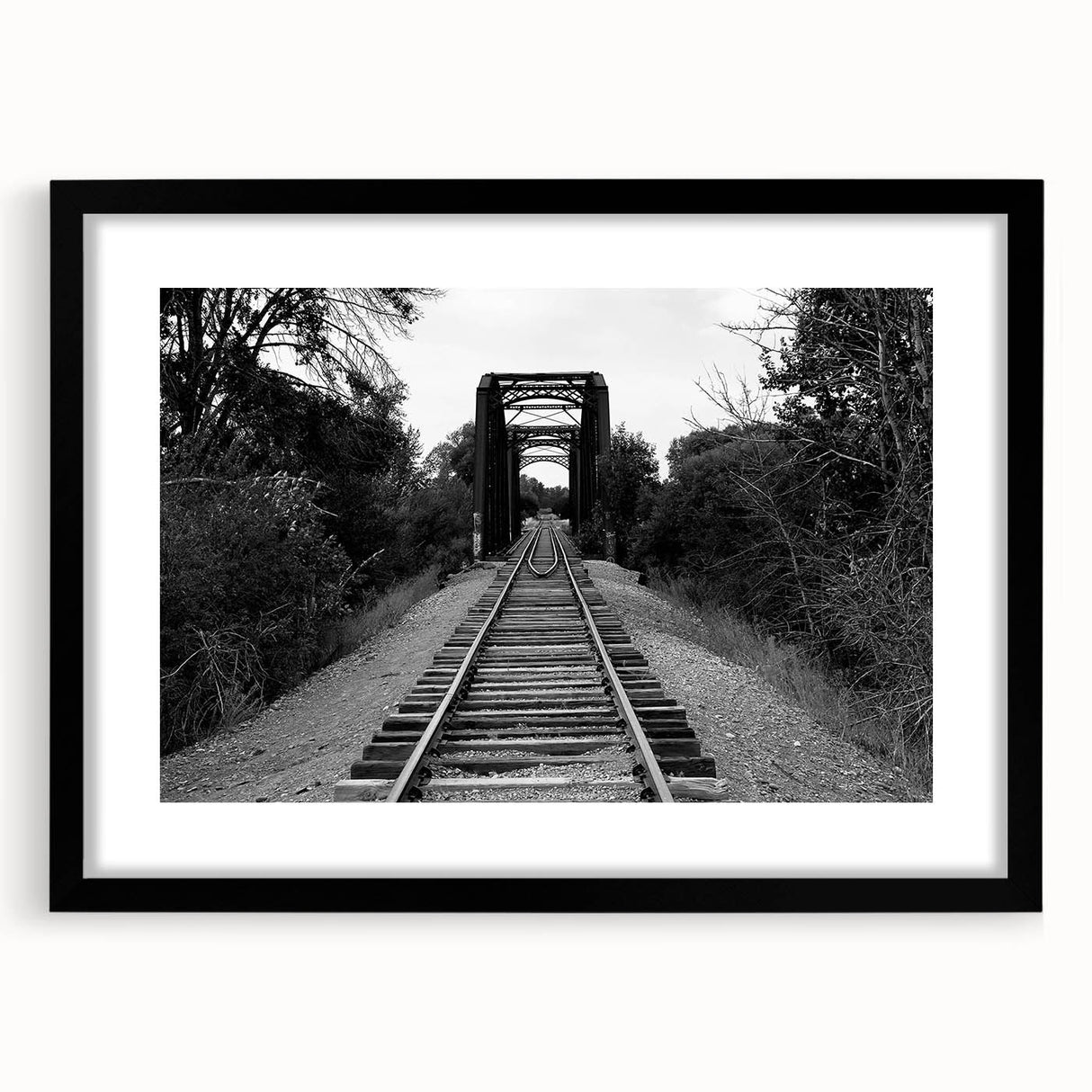 Framed wall art featuring a stunning landscape of railroads, presented in a sleek black frame with a mat. Perfect for enhancing home decor and showcasing artistic design.