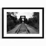 Framed wall art featuring a stunning landscape of railroads, presented in a sleek black frame with a mat. Perfect for enhancing home decor and showcasing artistic design.
