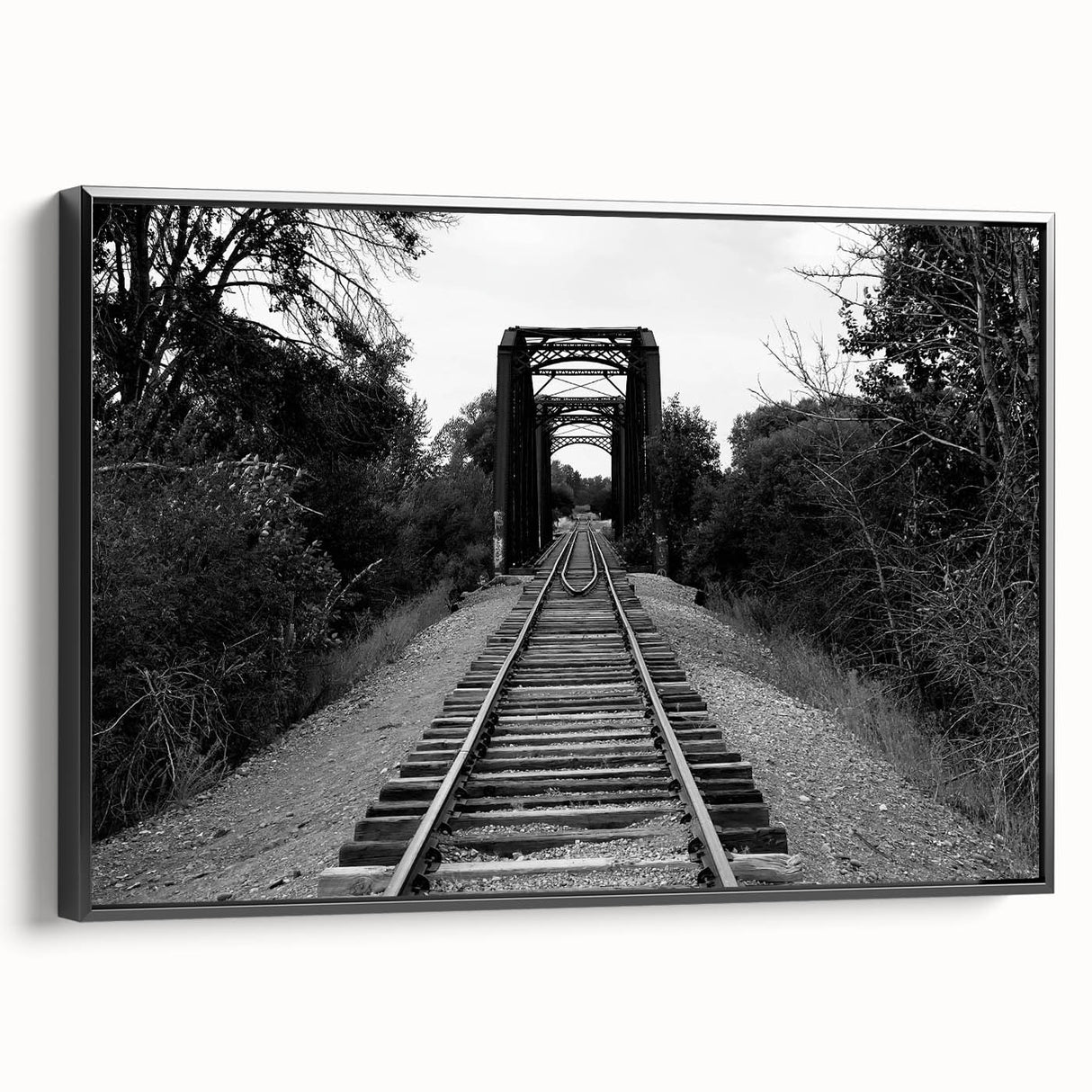 Framed black canvas wall art featuring a landscape railroad design, showcasing intricate details and vibrant colors, perfect for modern home decor.