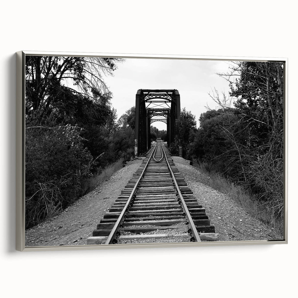 Framed canvas wall art showcasing a serene landscape with a railroad, featuring silver accents and a modern design, perfect for enhancing home decor.