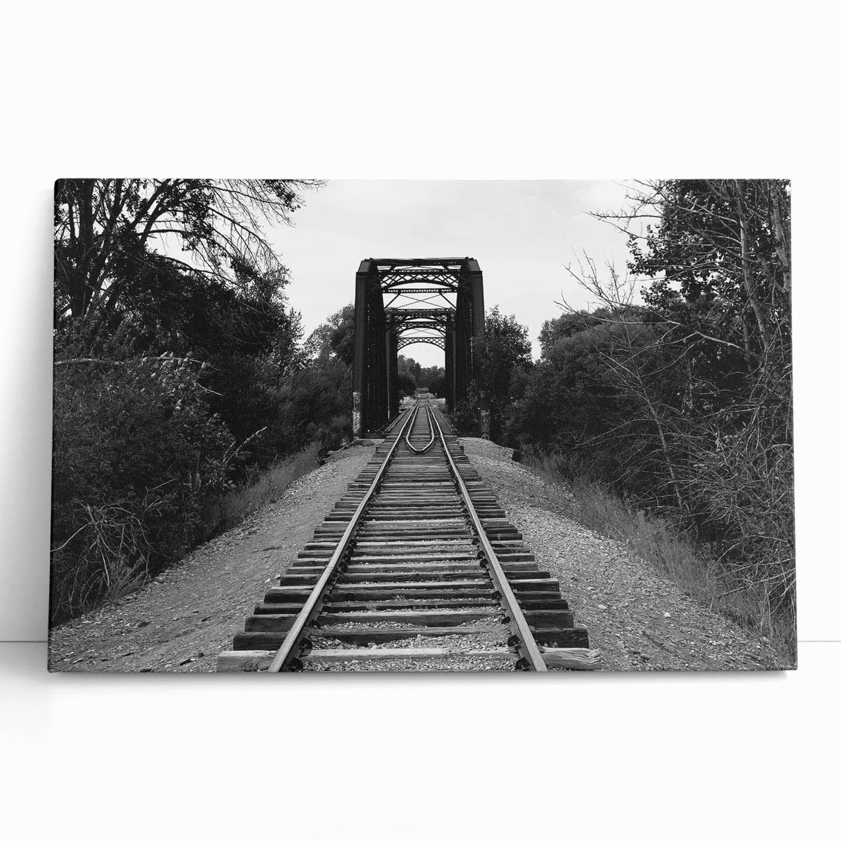 Stretched canvas artwork showcasing a vibrant landscape with a railroad theme, leaning against a wall, ideal for home or office decor, enhancing any space with its colorful design.