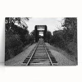 Stretched canvas artwork showcasing a vibrant landscape with a railroad theme, leaning against a wall, ideal for home or office decor, enhancing any space with its colorful design.