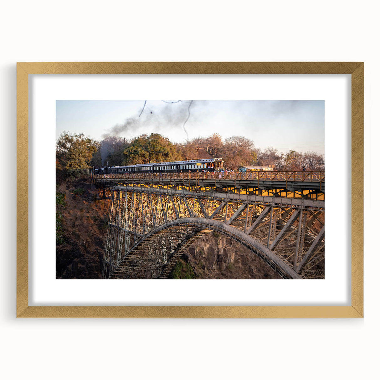 Gold-framed landscape wall art featuring a railroad design, elegantly matted for display. Ideal for enhancing interior decor with a touch of sophistication.