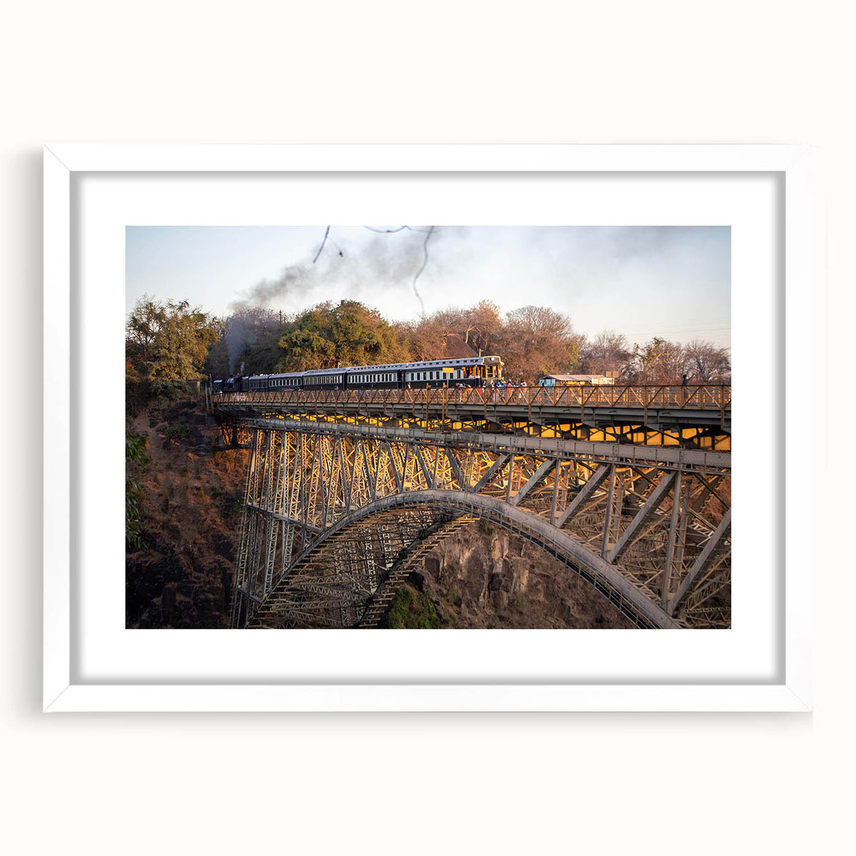 Framed landscape wall art featuring a serene railroad scene with lush greenery and soft clouds, presented in a white mat and frame, perfect for home decor.
