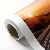 Rolled canvas artwork showcasing a vibrant landscape of a railroad scene, featuring rich colors and intricate details, perfect for enhancing modern home decor.