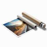 Vibrant rolled print showcasing a scenic landscape with a railroad track, perfect for home decor. The artwork features rich colors and intricate details, emphasizing the serene beauty of nature and transportation. Ideal for adding a touch of elegance to any room.