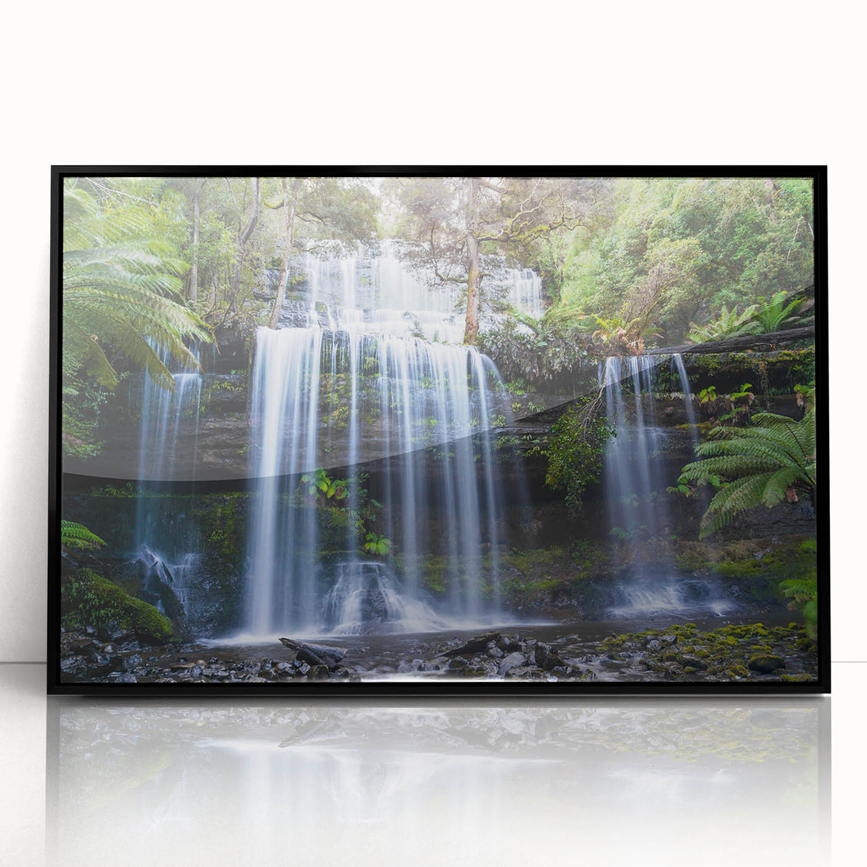 Framed acrylic wall art showcasing a vibrant rainforest landscape design with rich greens and blues, ideal for enhancing any modern living space.