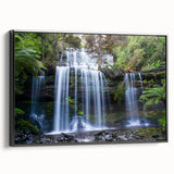 Framed canvas wall art showcasing a vibrant rainforest design, featuring lush green foliage and colorful tropical flowers, presented in a sleek black frame.